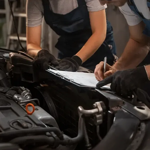 Technicians working on a car engine