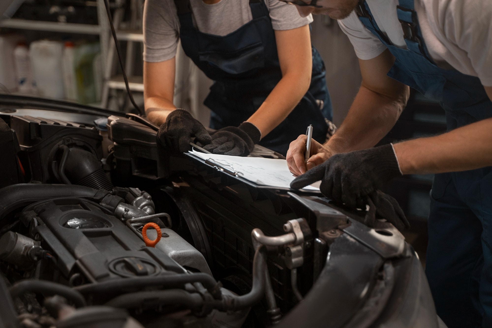 Technicians working on a car engine